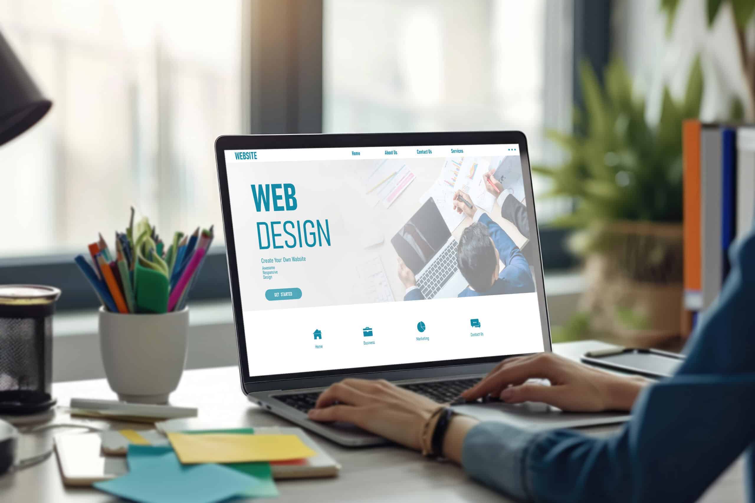 Business owner reviewing a website design project on a laptop during the website planning and development process.