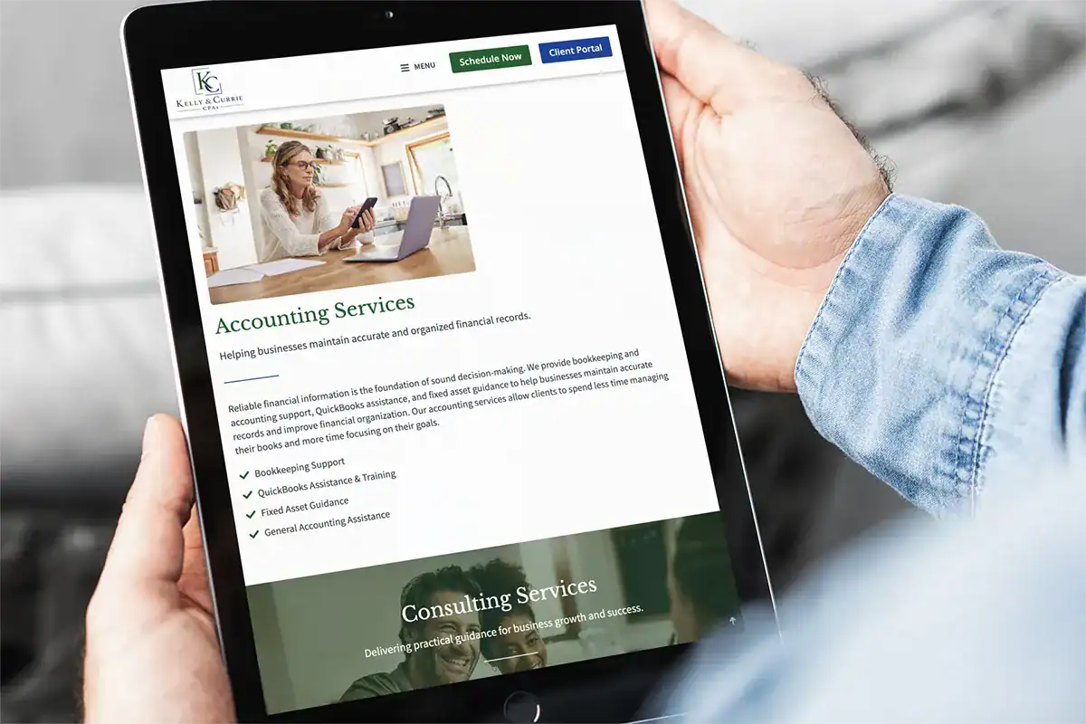 services for kelly & currie cpas shown on ipad being held by man